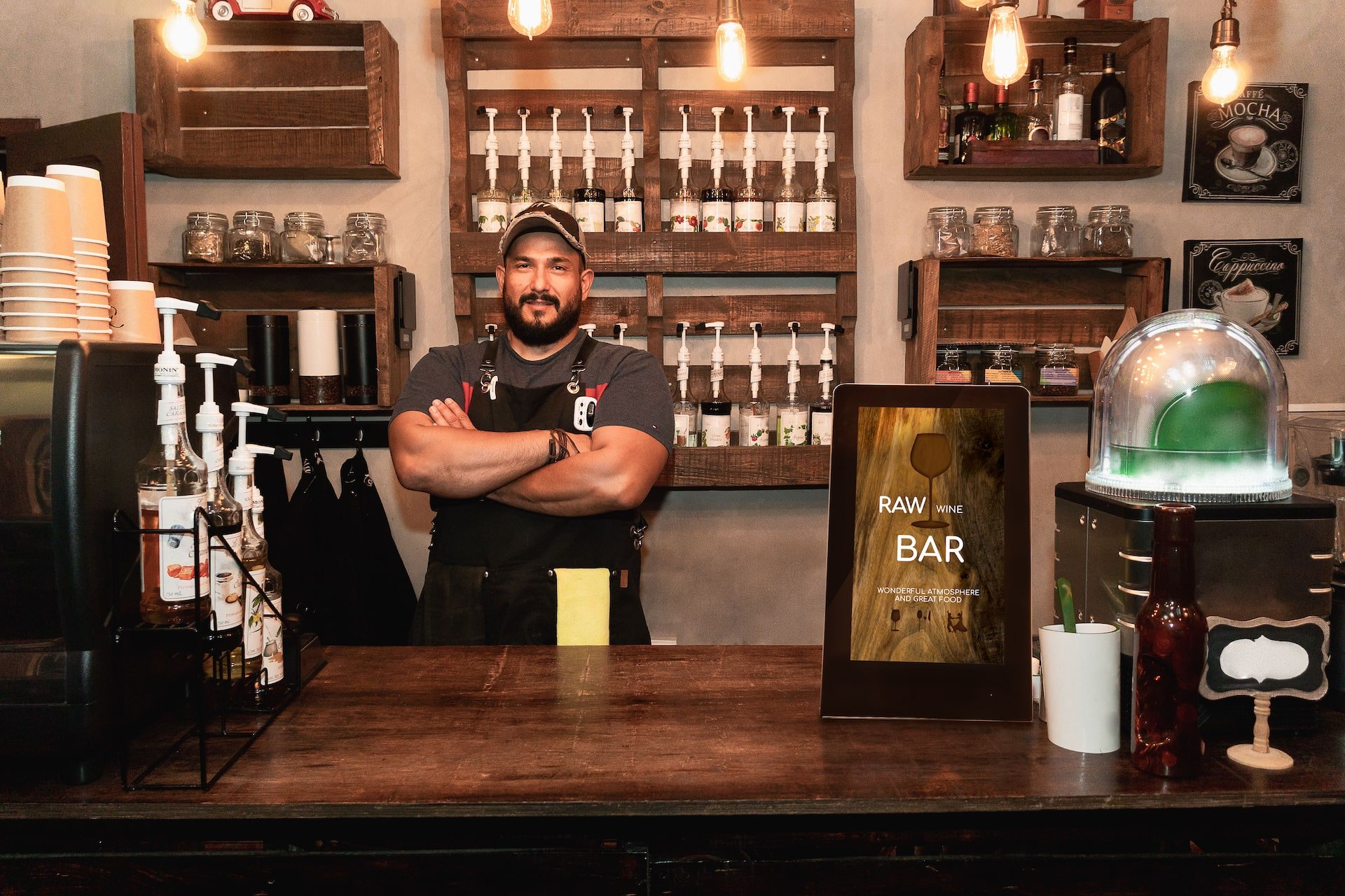 Digital table tent displaying match schedule and promotions in a sports bar